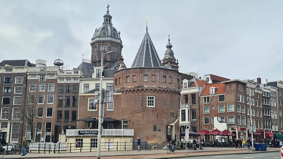 Amsterdam, Netherlands – March 21, 2023: Traditional houses in the downtown of Amsterdam.