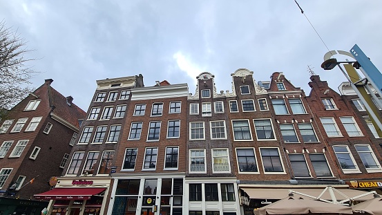 Amsterdam, Netherlands – March 21, 2023: Traditional houses in the downtown of Amsterdam.