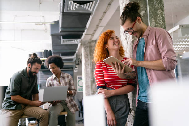 istock Young startup business people having fun, working and chatting at workplace office 1502289171