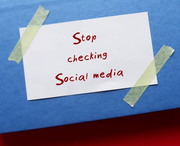 istock On blue book, handwritten stick note STOP CHECKING SOCIAL MEDIA, decision making to stay away from social media to gain more time to something else, less distracted and less stressed 1502289252