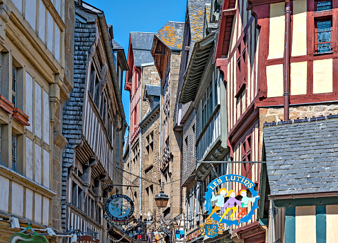narrow street with medieval buildings at Mont-Saint-Michel in the Normandy, France