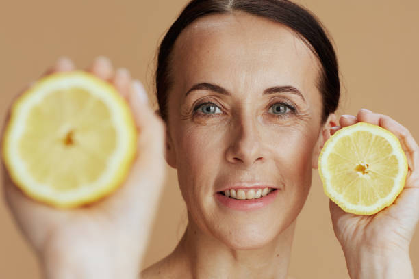 istock happy modern female with lemon against beige background 1502292026