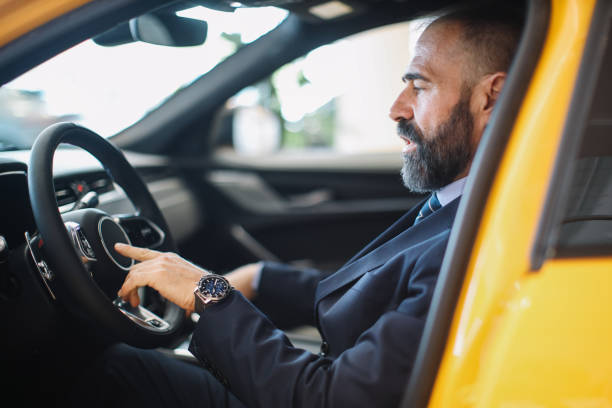 istock mid aged businessman looking for a new car 1502293096