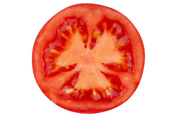 istock A cut piece of tomato isolated on a white background. 1502295851