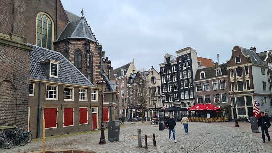 Amsterdam, Netherlands – March 21, 2023: Traditional houses in the downtown of Amsterdam.