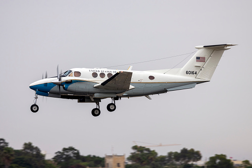 Luqa, Malta - June 10, 2023: US Air Force (USAF) Beechcraft C-12C Huron (Reg: 76-0164) on finals runway 31 on a cloudy afternoon.
