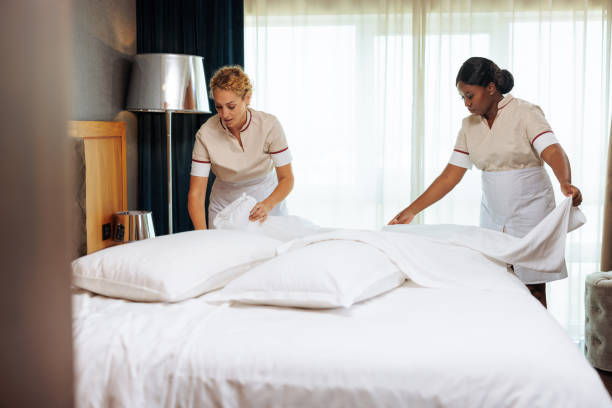 istock Two diverse maids preparing clean pillowcases together 1502304346