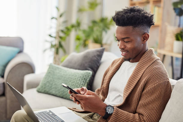 Typing, black man and phone for online shopping, ecommerce and communication for payment, transaction or sale. Customer, person and reading notification, alert or e ccommerce on technology in home