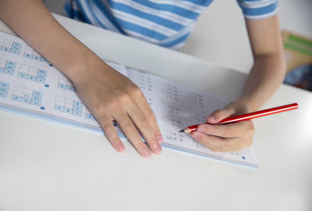 istock Close-up of a child doing homework at home. Education concept. 1502308208