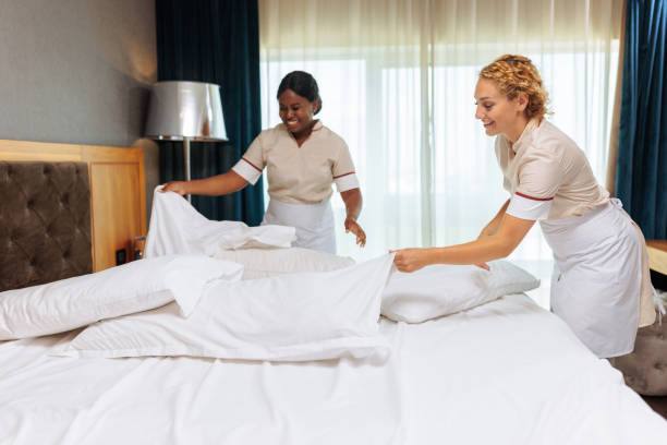 istock Interracial hotel maids having fun while putting clean pillowcases on 1502311605
