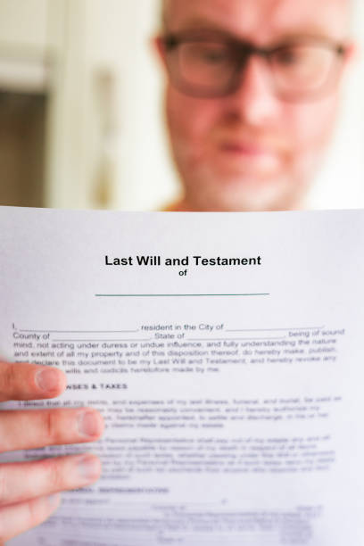 istock Mid adult man looking at Last Will and Testament document 1502313608
