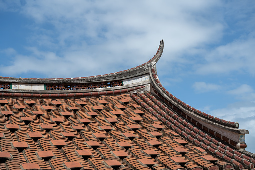new and old tiles line the roof of the house