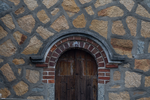 Ancient oak front door to cottage in Stanton in Cotswold or Cotswolds district of southern England in the autumn.