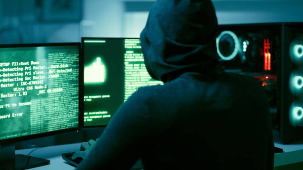 Back of hacker, person and dark computer for cybersecurity, ransomware and data password for crime. Error, thief and spy coding pc software for scam, phishing and hacking online firewall with malware