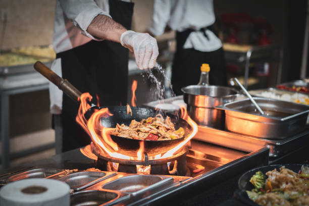istock Pouring some salt. Professional chef preparing food in the kitchen 1502322876