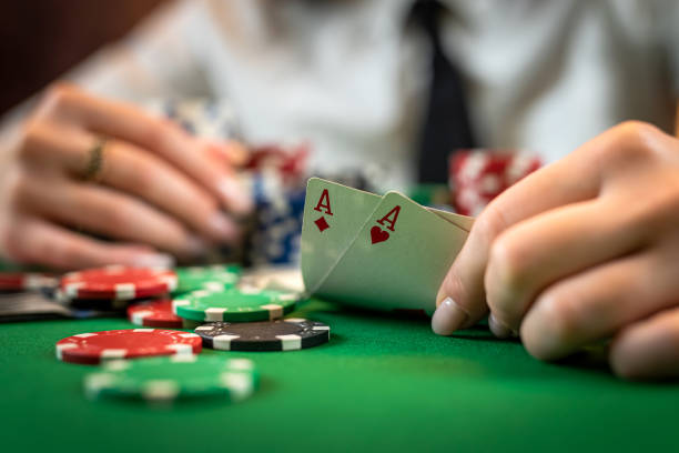 istock Greedy poker player after winning the game takes chips on a hundred dollar bill from the table. 1502322913