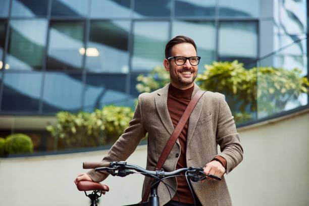 istock A successful businessman pushing his bicycle and going home from work. 1502323173