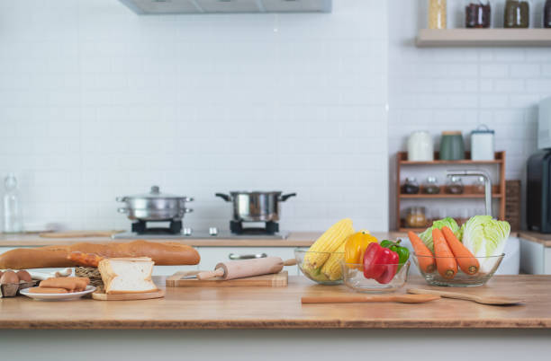 istock Vegetables and baking materials are set out on a wooden table, ready for cooking. To copyspace text. Concept of cooking with a kitchen in the background. 1502325128