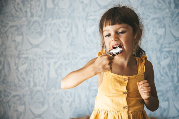 istock Little girl biting ice cream 1502327902