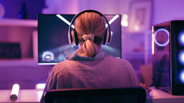 Neon, gaming and back of woman with pc for live streaming esports, video games or virtual competition. Desk, computer and female gamer with headphones for playing cyber, rpg and online game on screen Neon, gaming and back of woman with pc for live streaming esports, video games or virtual competition. Desk, computer and female gamer with headphones for playing cyber, rpg and online game on screen 4k gaming stock pictures, royalty-free photos & images