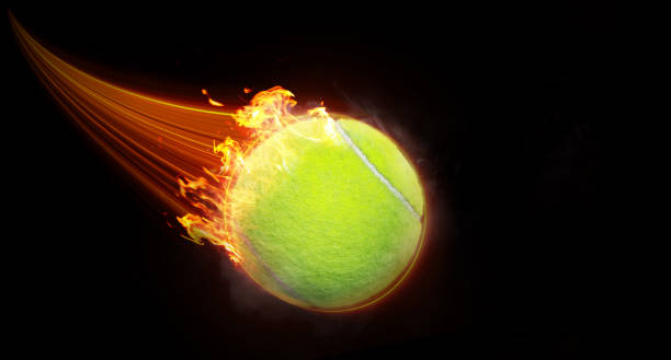 istock Tennis ball flying with fast magic effect in black background orange flame. 1502339240