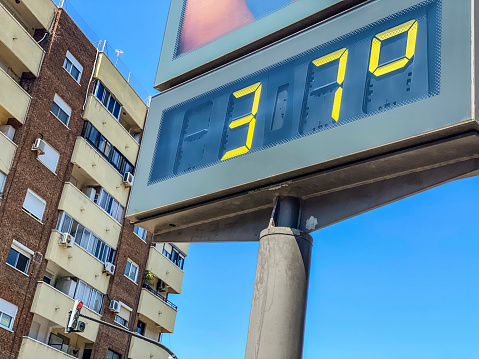 Low angle view of billboard showing 37 degrees celsius of temperature in the city of Valencia, Spain