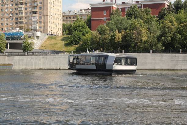 Pleasure boats on the Moscow River. Motor ships sail along the river on a rainy day