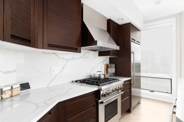 istock A kitchen with wood cabinets and white marble countertops. 1502368857
