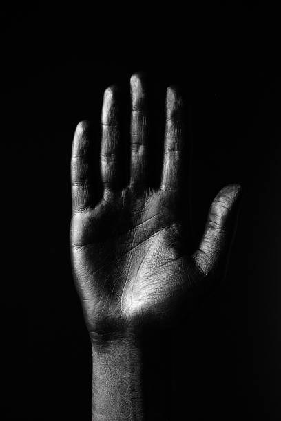 istock Black hand on white background, isolated, paint. 
Male hand isolated on black background. Hand showing symbols and gestures. 1502371192