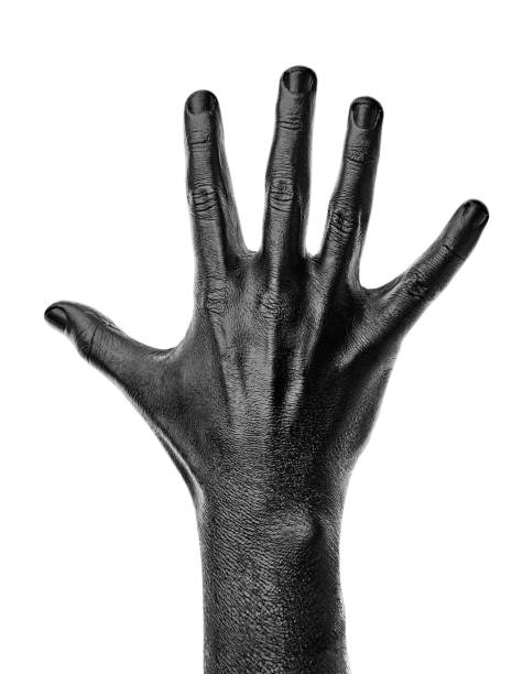 istock Black hand on white background, isolated, paint. 
Male hand isolated on black background. Hand showing symbols and gestures. 1502372984
