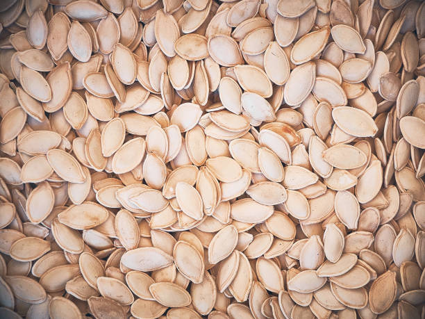 istock Dried pumpkin seeds background close up 1502385937