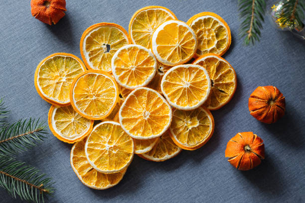 istock Dried sliced oranges on blue background. Top view. Cozy winter decoration. 1502386117