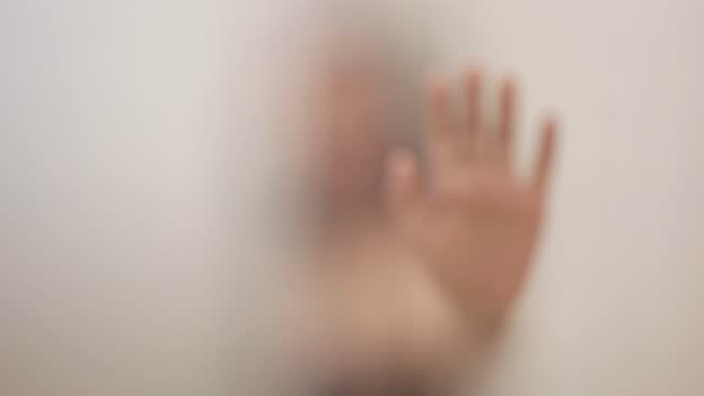 Woman hands in silhouette bathroom glass.
