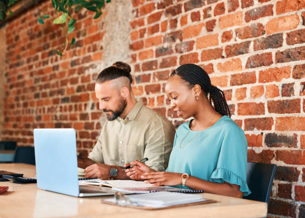 istock Laptop, restaurant and business people with remote work, startup career and project planning, documents and teamwork. Coworking, paperwork and diversity of entrepreneur, woman and partner at cafe 1502387769