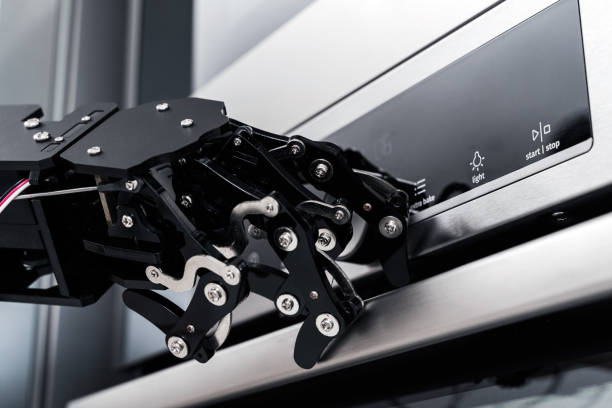 istock Real robot's hand and electric oven. Concept of robotic process automation 1502391053