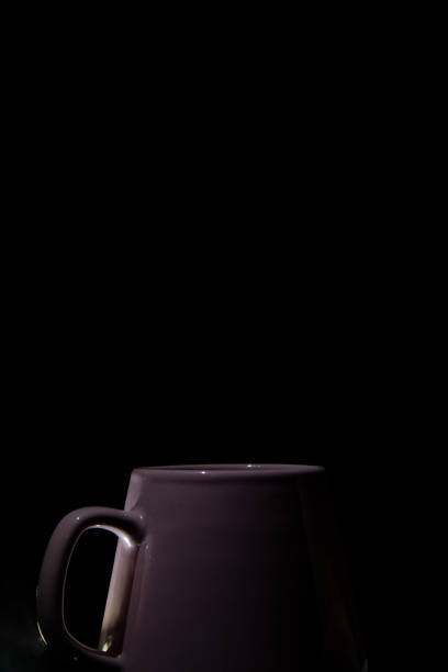 istock ceramic cup of pink color on a black background vertical photo isolated one object 1502393595