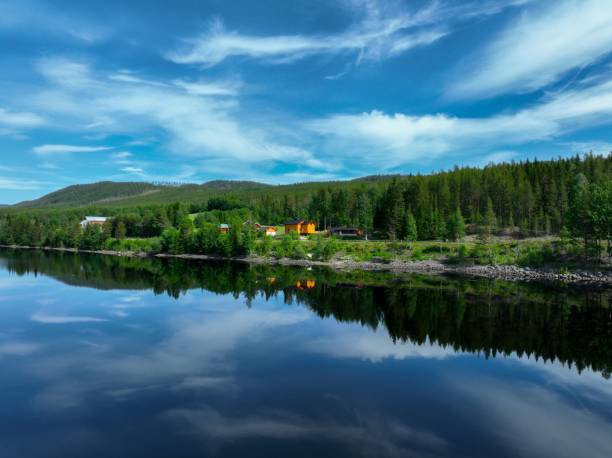 istock the reflection of a house in a still moving river water 1502394158