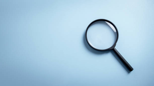 istock Top view empty lens black magnifying glass on white blue pastel background. Flat lay object and inspection investigate science equipment tool concept. Police forensic science theme. Copy space. 1502401685