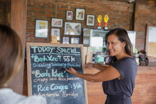 istock Vietnamese Restaurant Manager Showing Special Menu of the Day 1502411334