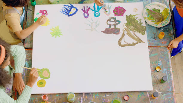 istock Art, workshop and children painting on a canvas in school for creative learning, lesson or knowledge. Brushes, paint and kid students or friends creating artwork on a board with mockup for education. 1502416697