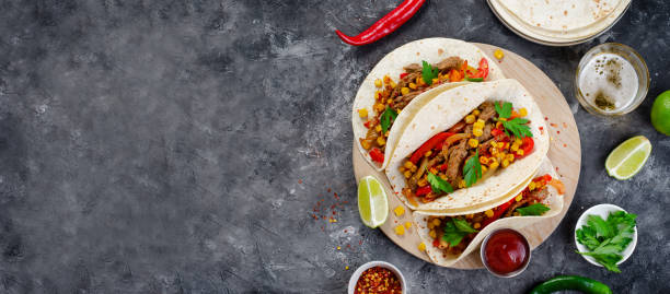 istock Mexican Tacos with Beef and Vegetables, Tacos al Pastor on Dark Background 1502416699