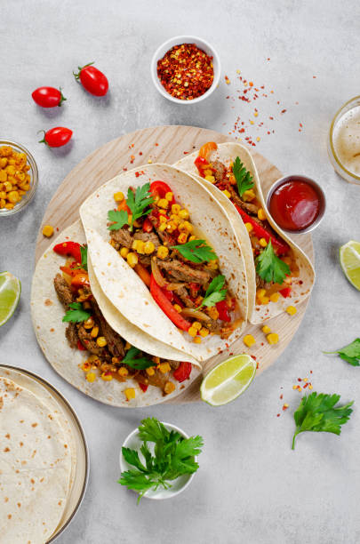 istock Mexican Tacos with Beef and Vegetables, Tacos al Pastor on Grey Background 1502418258