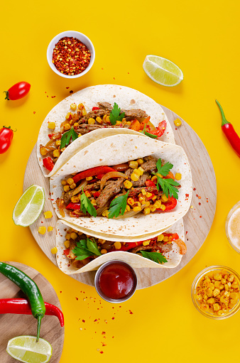 Mexican Tacos with Beef and Vegetables, Tacos al Pastor on Bright Yellow Background