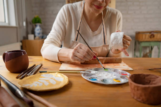 istock Woman painting a pottery 1502418497
