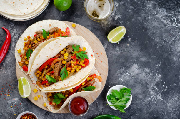 istock Mexican Tacos with Beef and Vegetables, Tacos al Pastor on Dark Background 1502418729