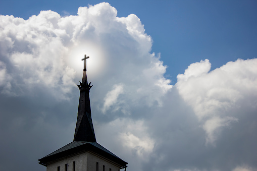 The cross on the church against the background of the sky.