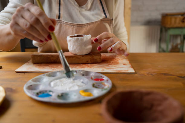 istock Female hands painting a pottery 1502419940