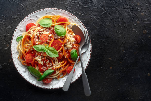 istock Spaghetti marinara, pasta with tomato sauce and basil, overhead flat lay 1502420702