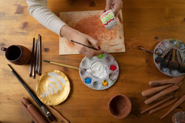 istock Female hands painting a pottery 1502420845