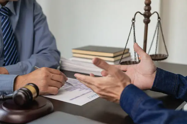 Justice Concepts and Legal Counsel presents signed contracts with clients with team meetings at law firms with perches and scales on the table.